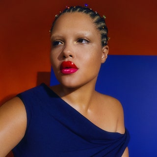 Three side by side images of a woman wearing a blue corset with braids and a pink lip in front of a red background